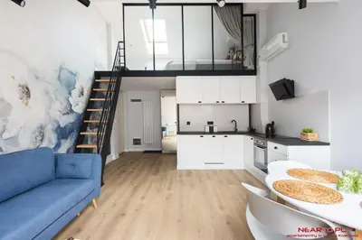a living room with a blue couch and a kitchen at Premium Apartment Old Town Topolowa in Kraków