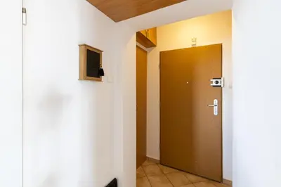 a hallway with a brown door in a room at ap4you Tauron Cracow in Kraków