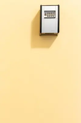 a black and white object on a yellow wall at ap4you Tauron Cracow in Kraków