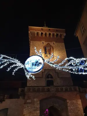a clock tower with christmas lights in front of it at ap4you Tauron Cracow in Kraków