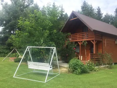 a swing in the yard in front of a house at Domek Nad Brzegiem in Witanowice