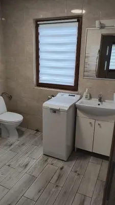a bathroom with a sink and a toilet and a mirror at Domek Nad Brzegiem in Witanowice