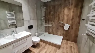 a bathroom with a sink and a toilet and a shower at Hotel Victoria in Olkusz