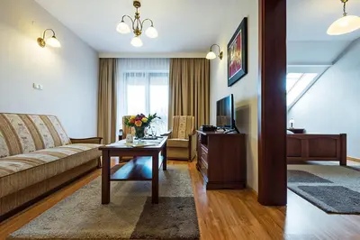 a living room with a couch and a table at Hotel Victoria in Olkusz