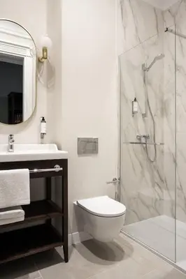 a bathroom with a shower and a toilet and a sink at Avanti Palazzo in Kraków