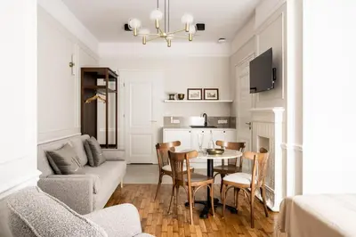 a living room with a table and chairs at Avanti Palazzo in Kraków