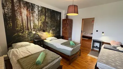 a room with two beds and a painting on the wall at Domek przy Rajskiej in Jerzmanowice