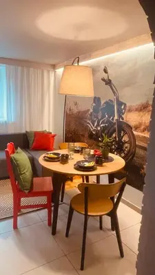 a living room with a table and chairs and a motorcycle at Domek przy Rajskiej in Jerzmanowice