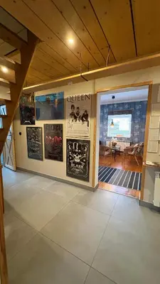 a room with posters on the wall and a dining room at Domek przy Rajskiej in Jerzmanowice