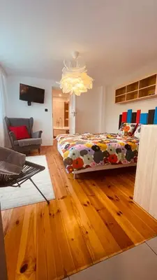 a bedroom with a bed and a living room at Domek przy Rajskiej in Jerzmanowice