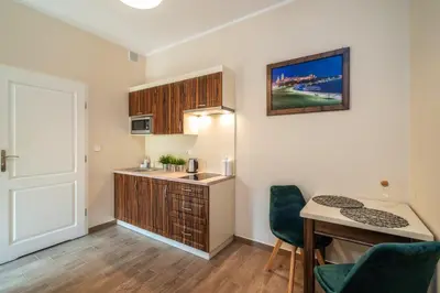 a small kitchen with a desk and a table at Apartments 17 Szewska in Kraków