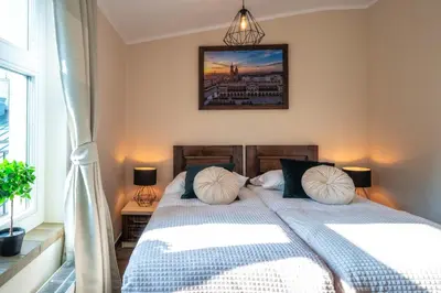 a bedroom with a bed with two pillows on it at Apartments 17 Szewska in Kraków