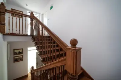 a wooden staircase in a home with white walls at Apartments 17 Szewska in Kraków