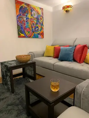 a living room with a couch and a table at Charming studio apartment in the heart of the Jewish District! in Kraków