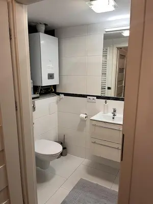 a bathroom with a toilet and a sink and a mirror at Charming studio apartment in the heart of the Jewish District! in Kraków
