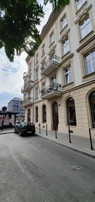 a large building with a car parked in front of it at Old Town Apartment, Morsztynowska in Kraków