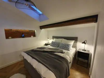 a bedroom with a large bed with a blue ceiling at Old Town Apartment, Morsztynowska in Kraków