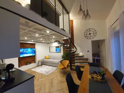 a living room with a couch and a dining room at Old Town Apartment, Morsztynowska in Kraków
