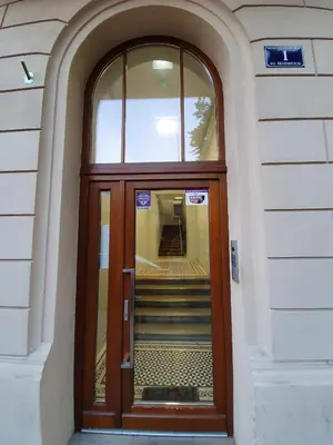 a wooden door with stairs in a building at Old Town Apartment, Morsztynowska in Kraków
