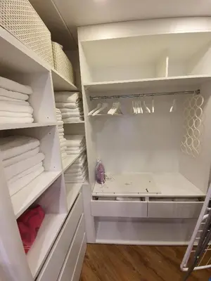 a white walk in closet with white shelves at Old Town Apartment, Morsztynowska in Kraków
