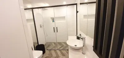 a white bathroom with a shower and a toilet at Old Town Apartment, Morsztynowska in Kraków