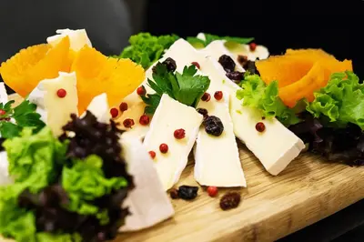 a bunch of appetizers on a wooden cutting board at Golden Tulip Krakow City Center in Kraków