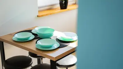 a wooden table with blue bowls and plates on it at Domek POD GOLCOWEM in Limanowa