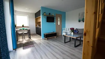 a living room with a couch and a table at Domek POD GOLCOWEM in Limanowa