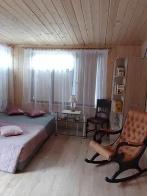 a bedroom with a bed and a chair and a window at Zajazd Ponikiew - Noclegi Wadowice in Wadowice