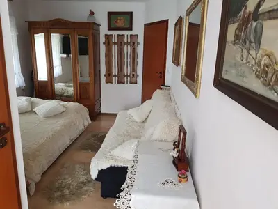 a living room with a couch and a bed at Zajazd Ponikiew - Noclegi Wadowice in Wadowice