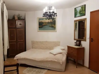 a bedroom with a bed and a dresser and a mirror at Zajazd Ponikiew - Noclegi Wadowice in Wadowice