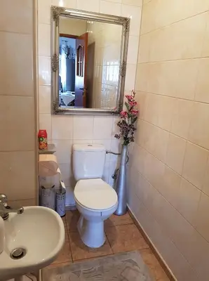 a bathroom with a toilet and a sink and a mirror at Zajazd Ponikiew - Noclegi Wadowice in Wadowice