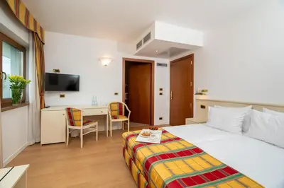 a hotel room with a bed and a desk and a table at Villa Królewiec - 1,5km od Energylandii in Zator