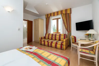 a hotel room with a bed and a couch and a chair at Villa Królewiec - 1,5km od Energylandii in Zator