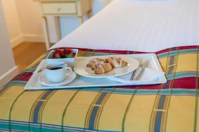 a tray of pastries and a cup of coffee on a bed at Villa Królewiec - 1,5km od Energylandii in Zator