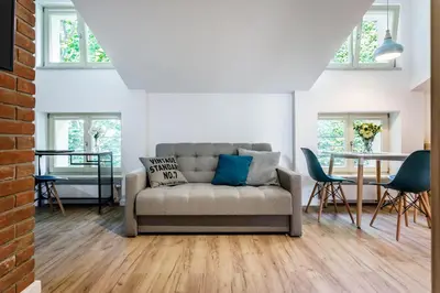 a living room with a couch and a table at MY KRAKOW Apartments - Topolowa 8 in Kraków