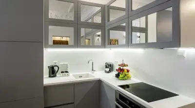 a kitchen with white cabinets and a sink at MY KRAKOW Apartments - Topolowa 8 in Kraków
