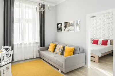a living room with a couch and a bed at MY KRAKOW Apartments - Topolowa 8 in Kraków
