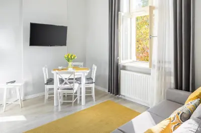 a living room with a table and a couch at MY KRAKOW Apartments - Topolowa 8 in Kraków
