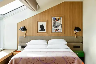 a bedroom with a large bed with two lamps at PURO Kraków Stare Miasto in Kraków