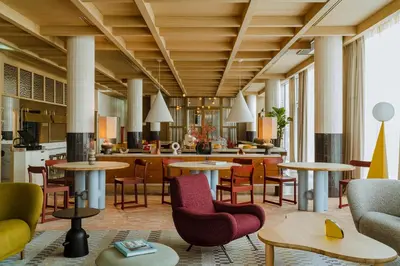 a lobby of a hotel with tables and chairs at PURO Kraków Stare Miasto in Kraków
