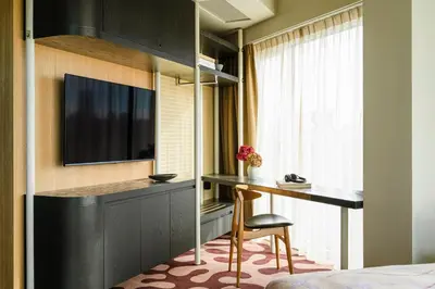 a hotel room with a desk and a television at PURO Kraków Stare Miasto in Kraków