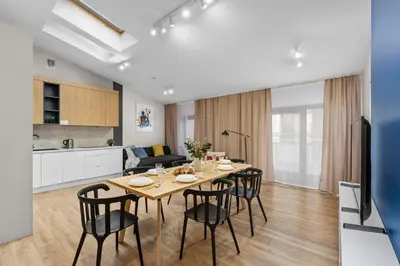 a living room with a table and a couch at Szewska 7 Apartments in Kraków
