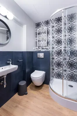 a bathroom with a toilet and a sink and a shower at Szewska 7 Apartments in Kraków