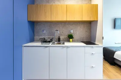 a dining room and living room with a table and chairs at Szewska 7 Apartments in Kraków