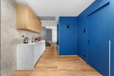 a kitchen with white cabinets and a sink at Szewska 7 Apartments in Kraków