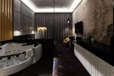 a large bathroom with a tub and a tv at Starowiślna VIP Apartamenty JACUZZI in Kraków