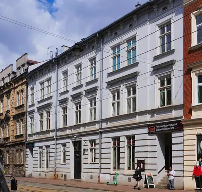 a white building on the side of a street at Starowiślna VIP Apartamenty JACUZZI in Kraków