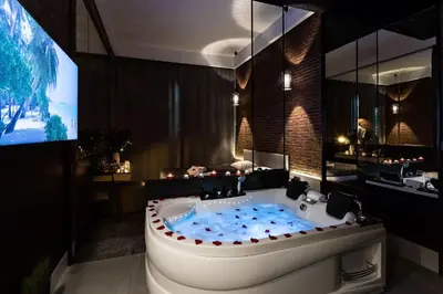 a large bathroom with a tub with a tv in it at Starowiślna VIP Apartamenty JACUZZI in Kraków