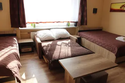 a room with two beds and a window at Róża Pustyni in Chrzanów